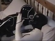 Cute college girl making out in latex catsuits
