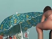 Nude sun tanning girls expose themselves to a beach